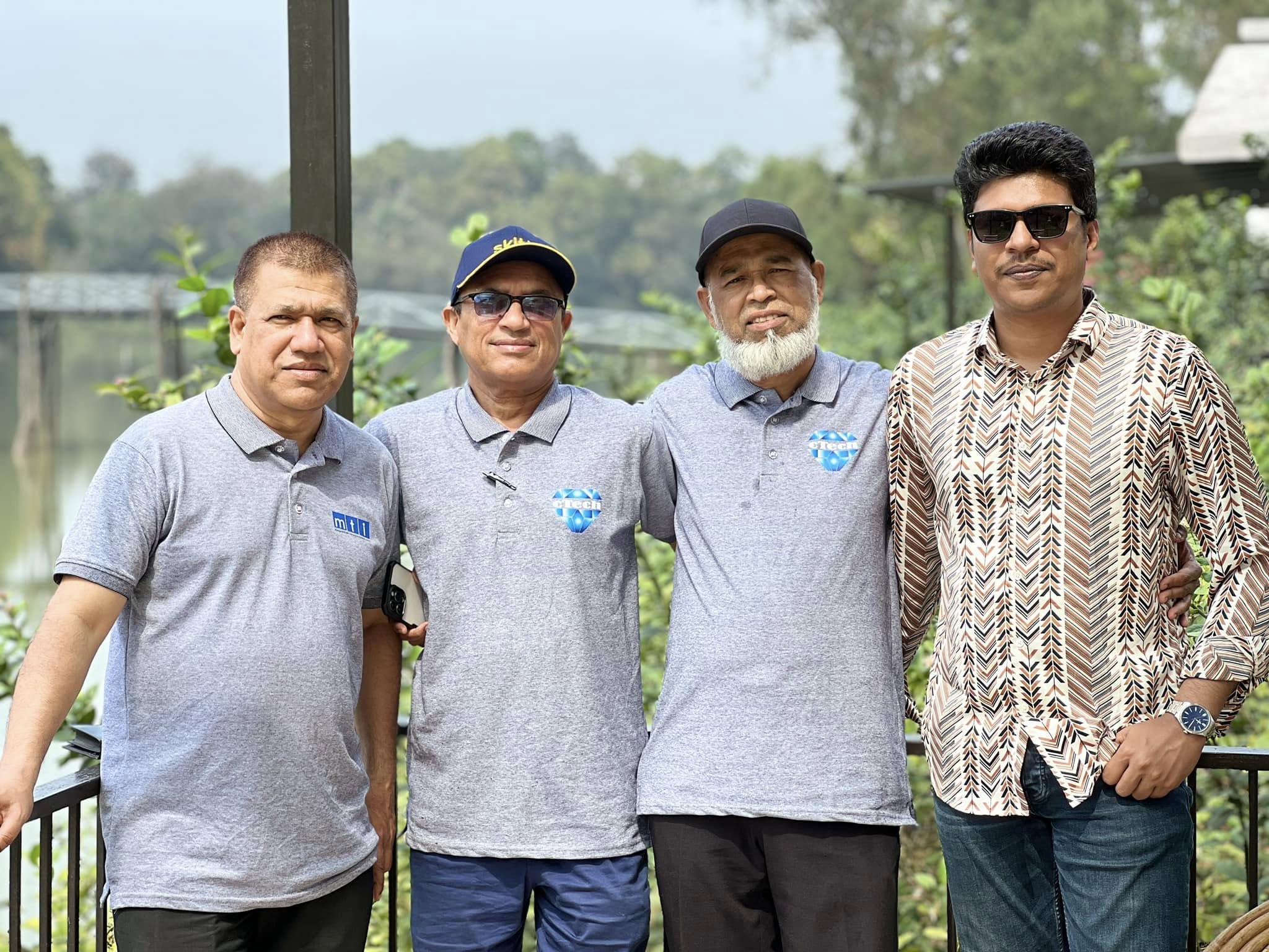 Raihan Khan and colleagues from MTI Ltd. and eTech pose together during a lakeside team outing.