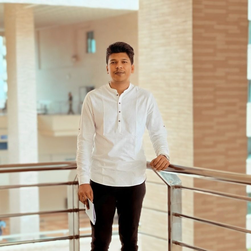 Raihan Khan posing on an indoor balcony overlooking the North South University atrium.