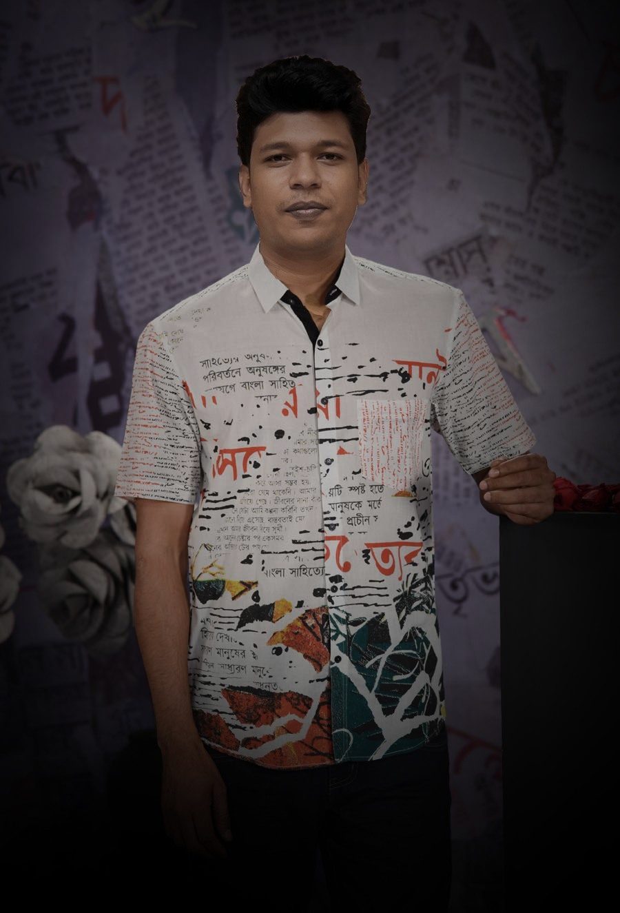 Raihan Khan in a newspaper-print shirt posing against a dark textured studio backdrop with floral accents.