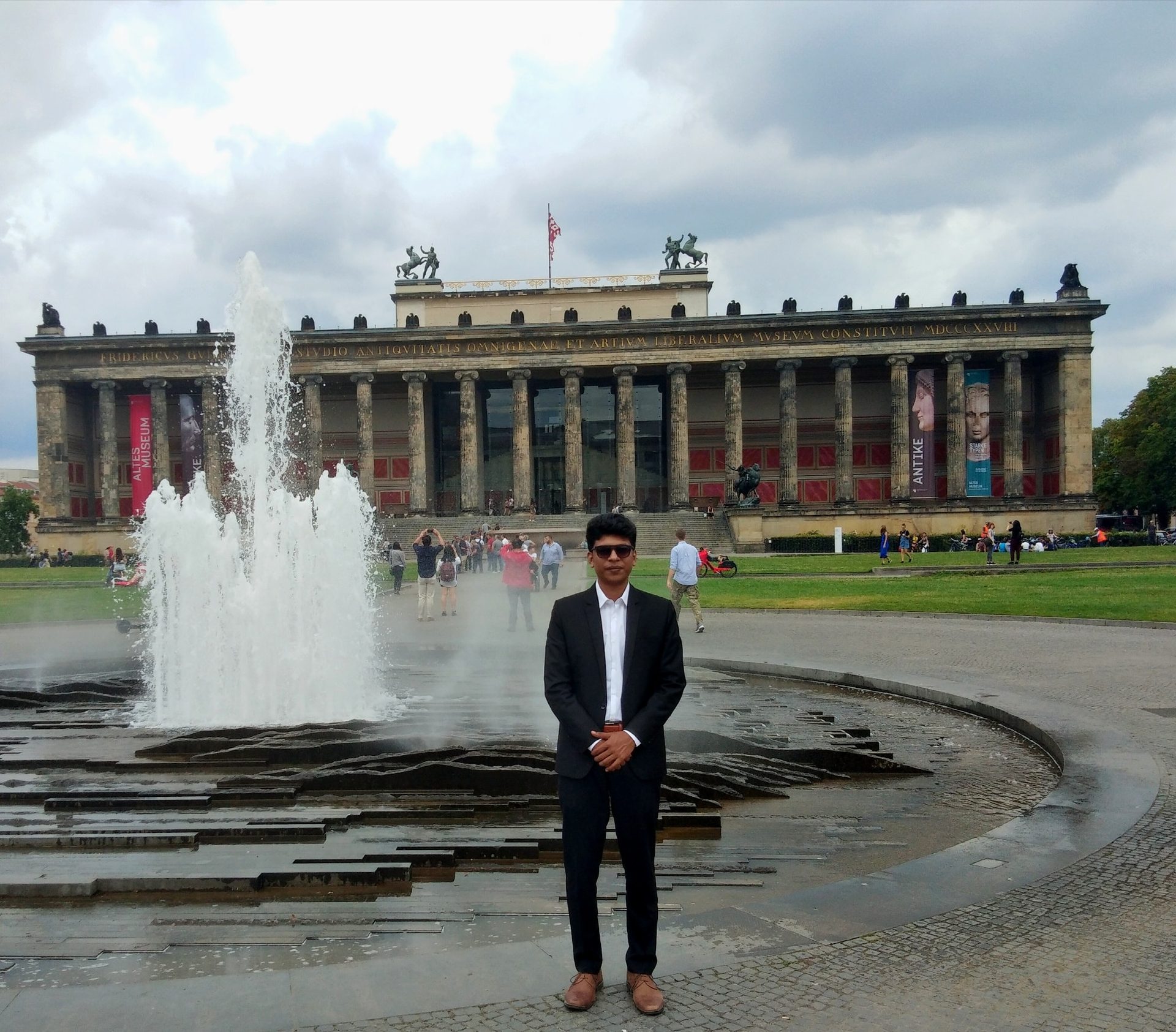 Raihan Khan standing before a fountain in front of the Altes Museum in Berlin.
